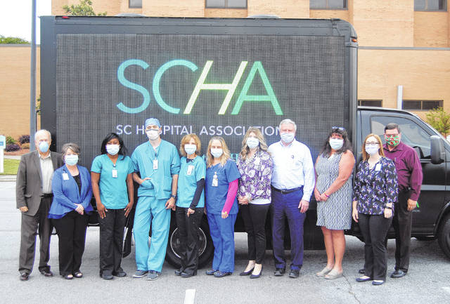 125049608_web1_DSC_0475
Staff members of the Newberry County Memorial Hospital visit the Healthcare Heroes Truck when it stopped by the hospital this month. Pictured, (L to R): Bruce Baldwin, CEO, Brenda Williams, Chelsea McMorris, Corey Bishop, Olivia Arnoult, Anita McCullough, Emily Metts, Bob Hetrick, CFO, Tina Hipp, Crystal Mitchell Scott Parton.
Andrew Wigger | The Newberry Observer