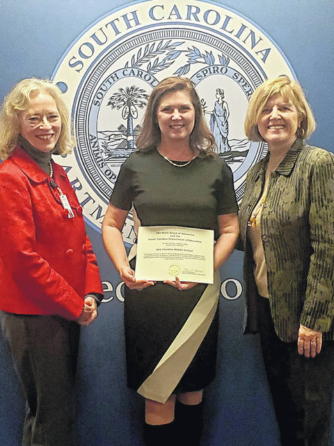 Mid-Carolina Middle School is one of 119 schools of the 167 recognized having maintained or increased their levels of excellence and are being redesignated. Pictured, left to right: Dr. Cynthia Downs, S.C. Board of Education member and Newberry resident; Deedee Westwood, principal; Molly Spearman, S.C. Superintendent of Education.
                                 Courtesy photo