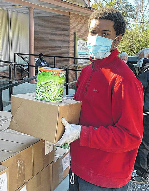 <p>Jamarrian Henley volunteered with the Living Hope Foundation to distribute food to those in need.</p>
<p>Courtesy photo</p>