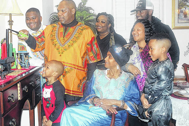 126219921_web1_thumbnail_Kinard-Kwanzaa-Group
The Kinard family celebrating the first night of Kwanzaa by lighting the center black candle. Pictured, the Kinard family, left to right: Carlton Kinard, Larry Kinard (Lighting Unity Candle), Christon Kinard-Smith, JaeCayla Barksdale, Brenda Kinard, TaQuala Kinard-Barksdale, Trey Kinard, Garrett Kinard-Smith (Black Panther).
Courtesy of Carlton Kinard