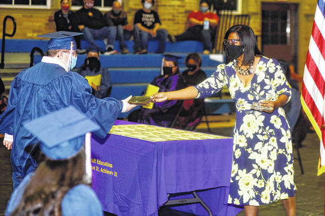 <p>Director Roberta Kinard presents an achievement award to Cannon Dickert.</p>
<p>Courtesy of Newberry Adult Ed.</p>