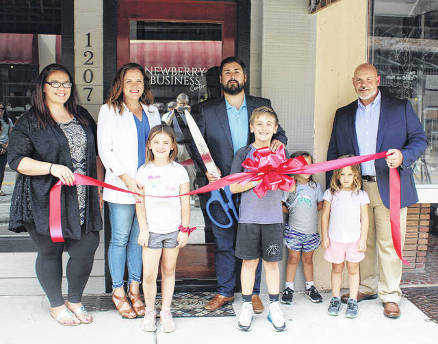 127169425_web1_IMG_0642
Newberry Business Center held a ribbon cutting, hosted by the Newberry County Chamber of Commerce, to celebrate their grand opening. Pictured, left to right: Alene Willingham (Newberry Business Center manager), Cayci Banks (1000 Feathers), McLane Banks, Charlie Banks (VentureSouth), Lucas Banks, Annie Banks, Mary Georgia Banks, and Chris Willingham (Venture Carolina).
Andrew Wigger | The Newberry Observer
