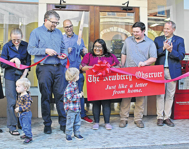 127901157_web1_IMG_3374
The ribbon is officially cut on The Newberry Observers new location at 1216 Main Street. Pictured, left to right: Laura Roost, Publisher Andy Husk, Editor Andrew Wigger, Inside Sales Rep. Rubi Flores, Sales Rep. Jared Harmon, Mayor Foster Senn, front: Oskar and Zyg Roost-Husk.
Mary Alex Kopp | For The Newberry Observer
