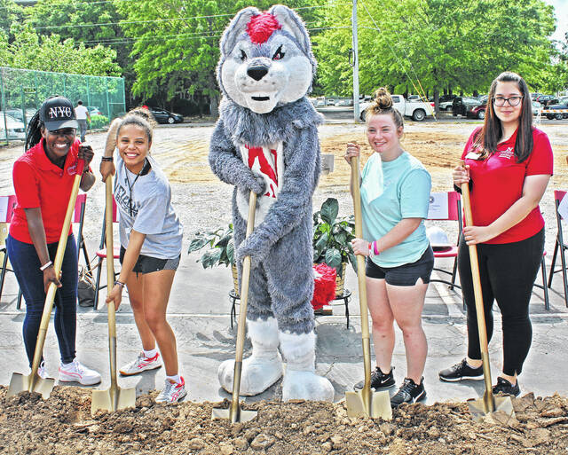 Newberry Colleges Stembile Chikoore, Yasmine De Meyer, Scar, Hannah Gable, and Kornelia Rudkowska (L-R) helped break ground for the new residence hall on the site of the old tennis courts.
                                 Andrew Wigger | The Newberry Observer