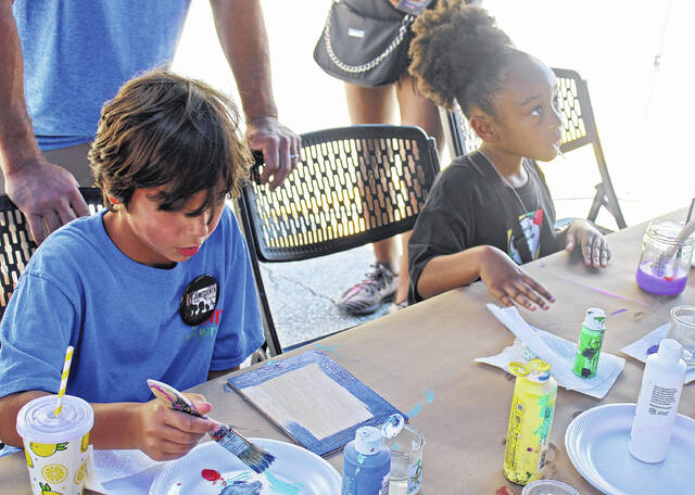 Children got the chance to paint with Ernest Lee, better known as South Carolinas Chicken Man, at the Newberry Arts Center on Main Street.
                                 Andrew Wigger | The Newberry Observer