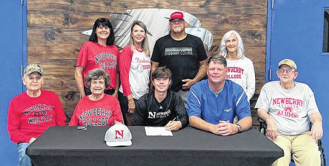128681832_web1_IMG_9445 
			
				                                James Graham (center) recently signed his letter of intent to play baseball at Newberry College. He is surrounded by his family and Coach Scott Gardner.
                                 Courtesy of Newberry Academy