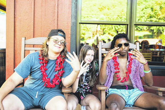 Connor Amick and Dacian Myers enjoying the luau with a friend they made at camp.
                                 Tori Steyne for The Newberry Observer