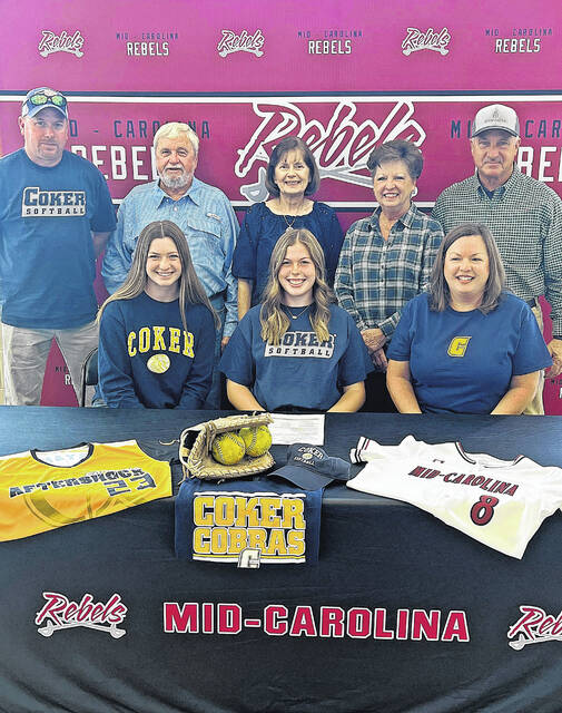 Sarah Bryant (center), a Mid-Carolina High School senior, signed to play softball at Coker University while surrounded by family.
Courtesy of MCHS