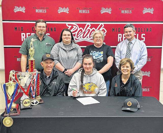 129421807_web1_FullSizeR
Clarissa Haltiwanger (center) has signed a letter of intent to be a member of the clay target team at Emmanuel College.
Courtesy at MCHS