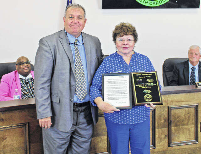 129846696_web1_IMG_2711
Mary Arrowood (right) holds up her recognition plaques in her final Newberry County Council meeting. She is pictured with Chairperson Todd Johnson (left).
Orion Griffin | The Newberry Observer
