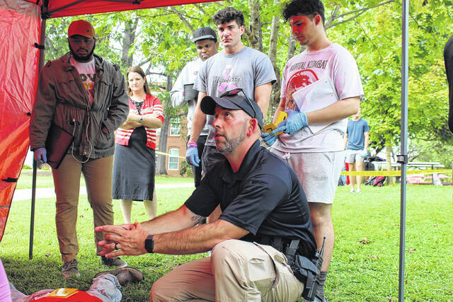 130242374_web1_IMG_2201
A Newberry police officer works with Newberry College criminal justice undergraduates on a mock crime scene, Sept. 21, 2023.