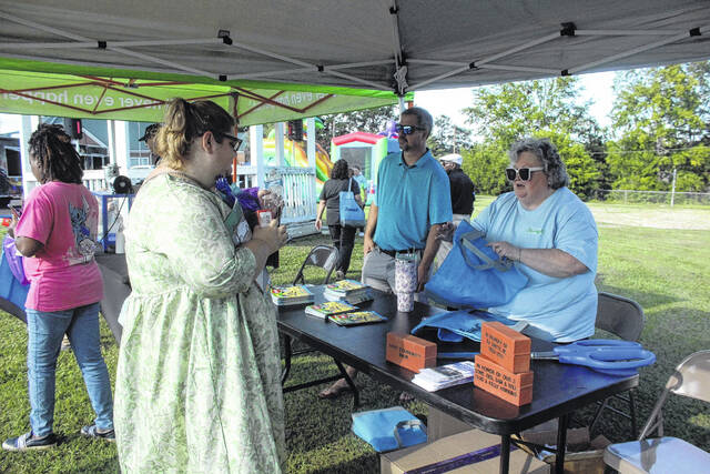 131746415_web1_2025-2
Town Administrator Karen Livingston hands out goodies to members of the community during National Night Out.
Kelly Duncan photos | The Newberry Observer