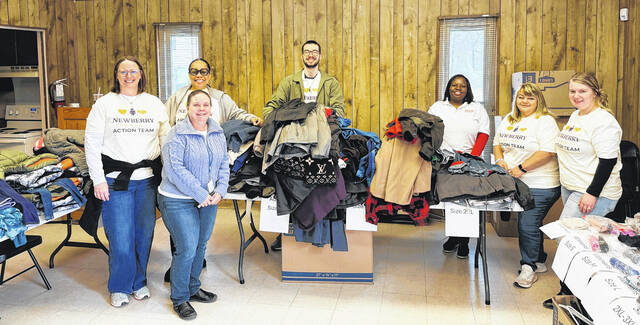 Members of the Newberry Community Action Team with several of the coat donations.
                                 Courtesy photo