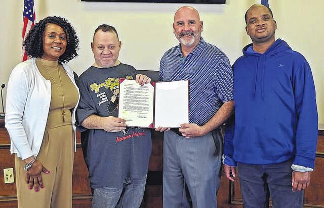 County Administrator Ted Luckadoo, center, presents the proclamation recognizing March as Disabilities Awareness Month in Newberry County. Representatives were unable to attend the meeting, but received the proclamation the following day.
                                 Newberry County Government
