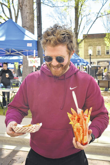 Dylan Francis samples a variety of foods during this years International Festival.