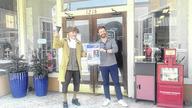 Last week, the town crier presented Newberry Observer Sales Representative Dylan Francis and staff with the first mini poster created by The Newberry Museum, in collaboration with the City of Newberry. Each posters theme is related to the business or organization. A QR code on the poster will take residents to the museums website with additional information about the poster and its theme.
                                 Kelly Duncan | The Newberry Observer