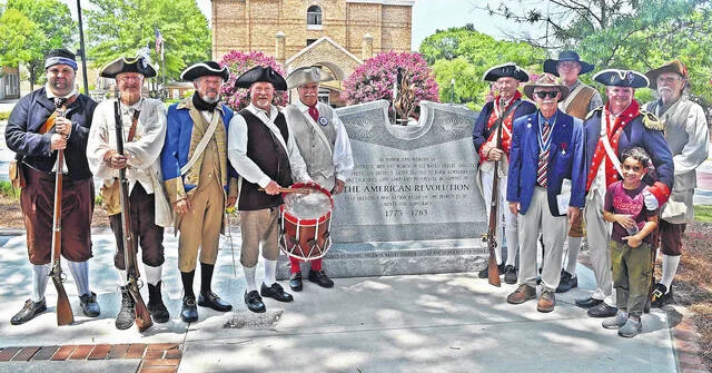 American Revolutionary Reenactors stand with the new American Revolution Monument in Memorial Park.
Andrew Wigger for The Observer